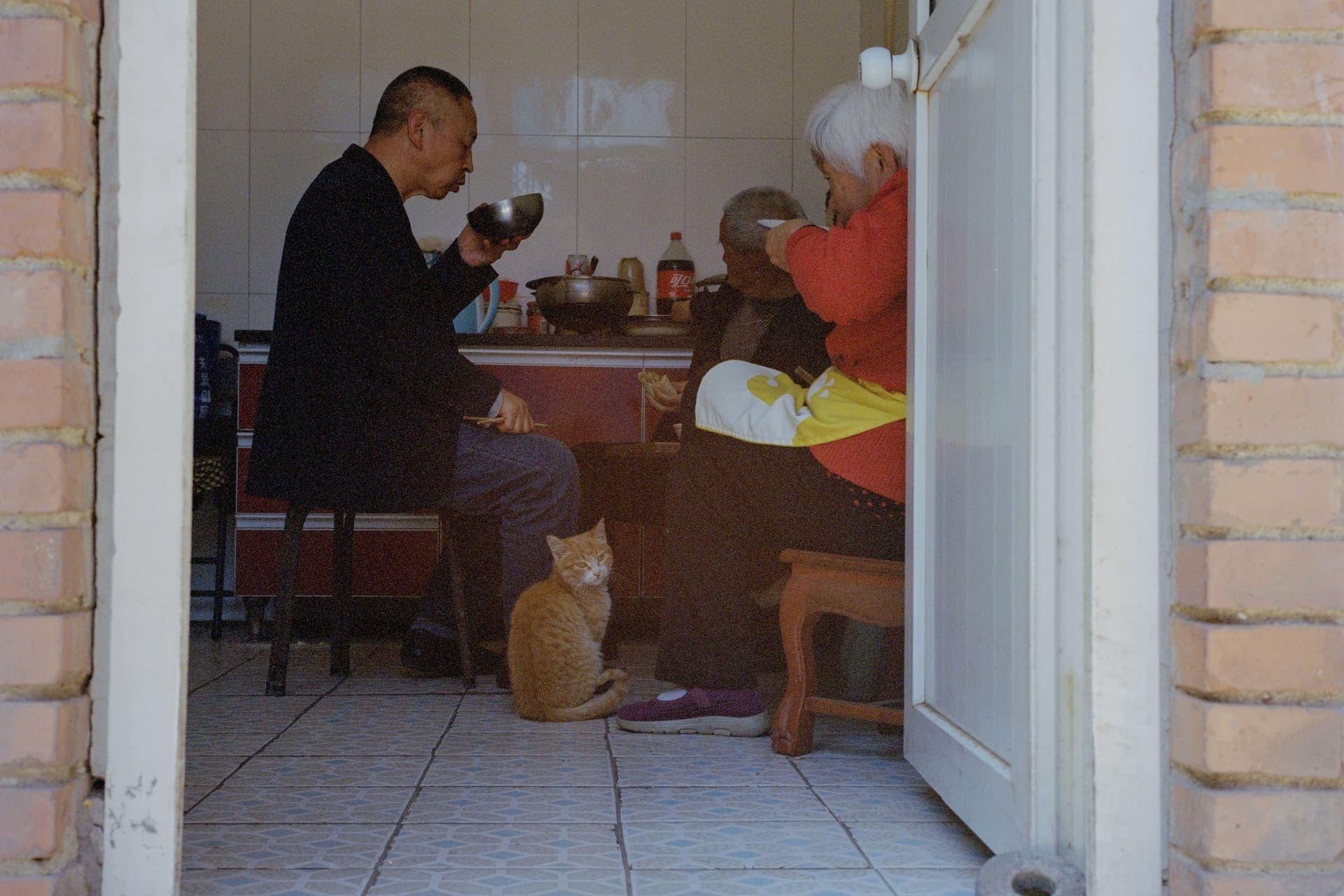 Elders and their family sharing a meal at a home table in Vietnam.